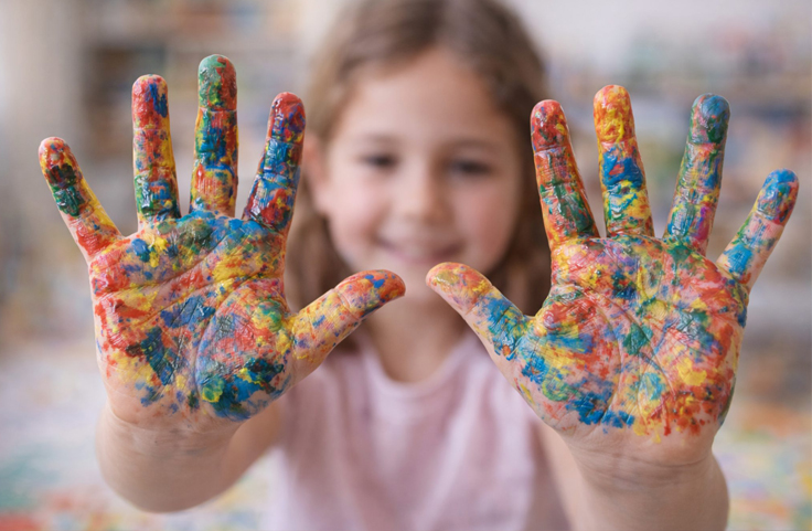 Child using figures in a sand tray during play therapy